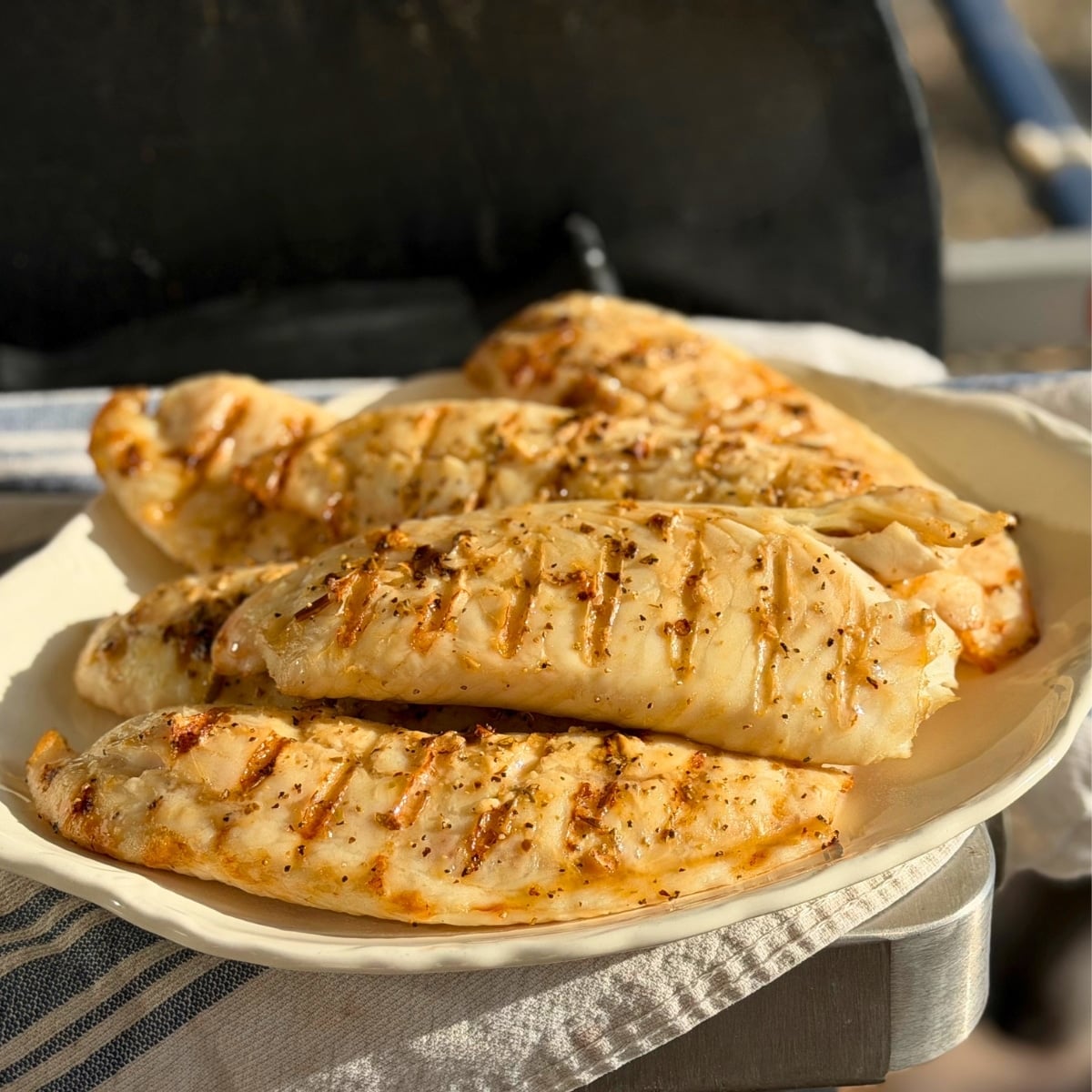 honey lime grilled tilapia onplatter next to bbq