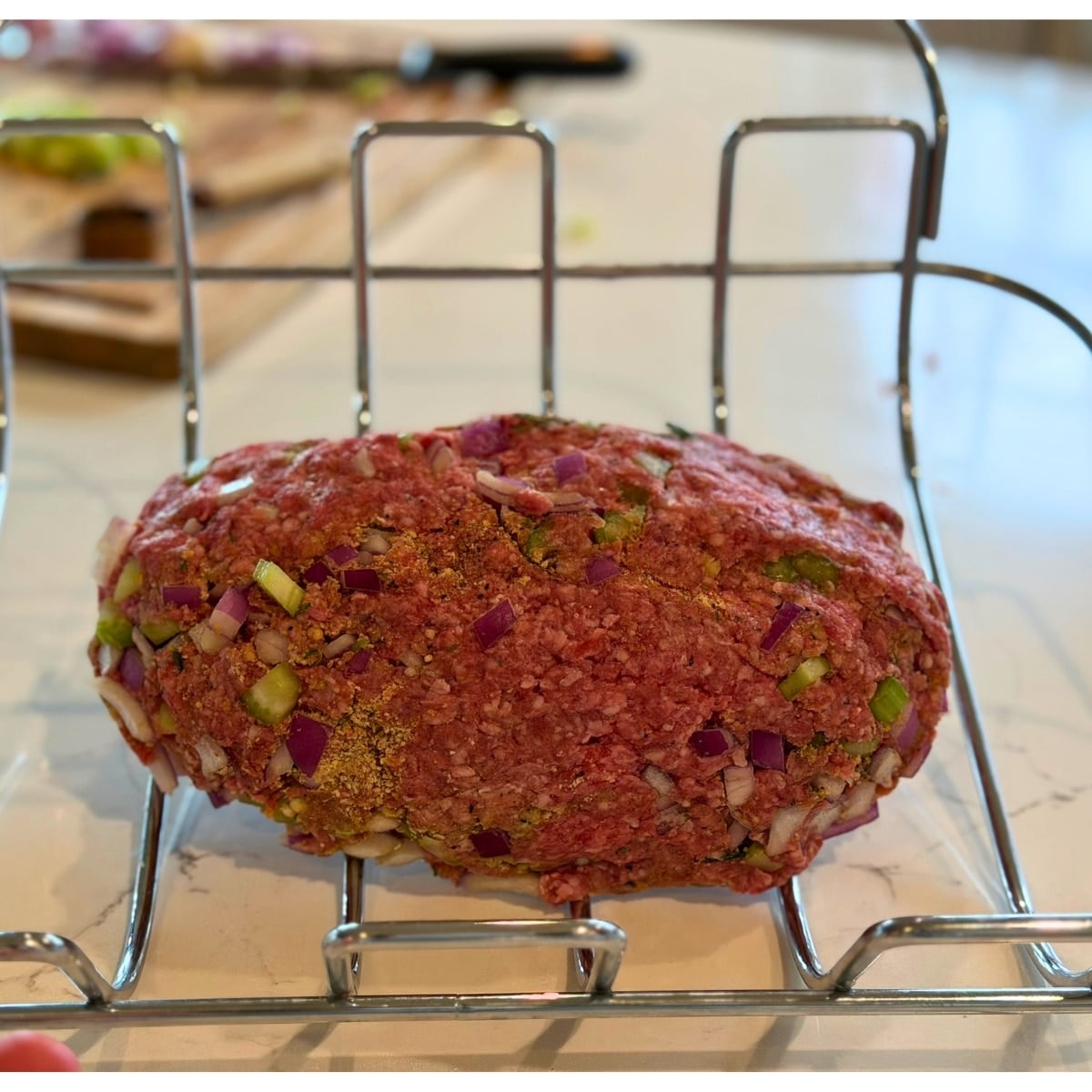 raw grilled meatloaf on roasting rack before placing on grill