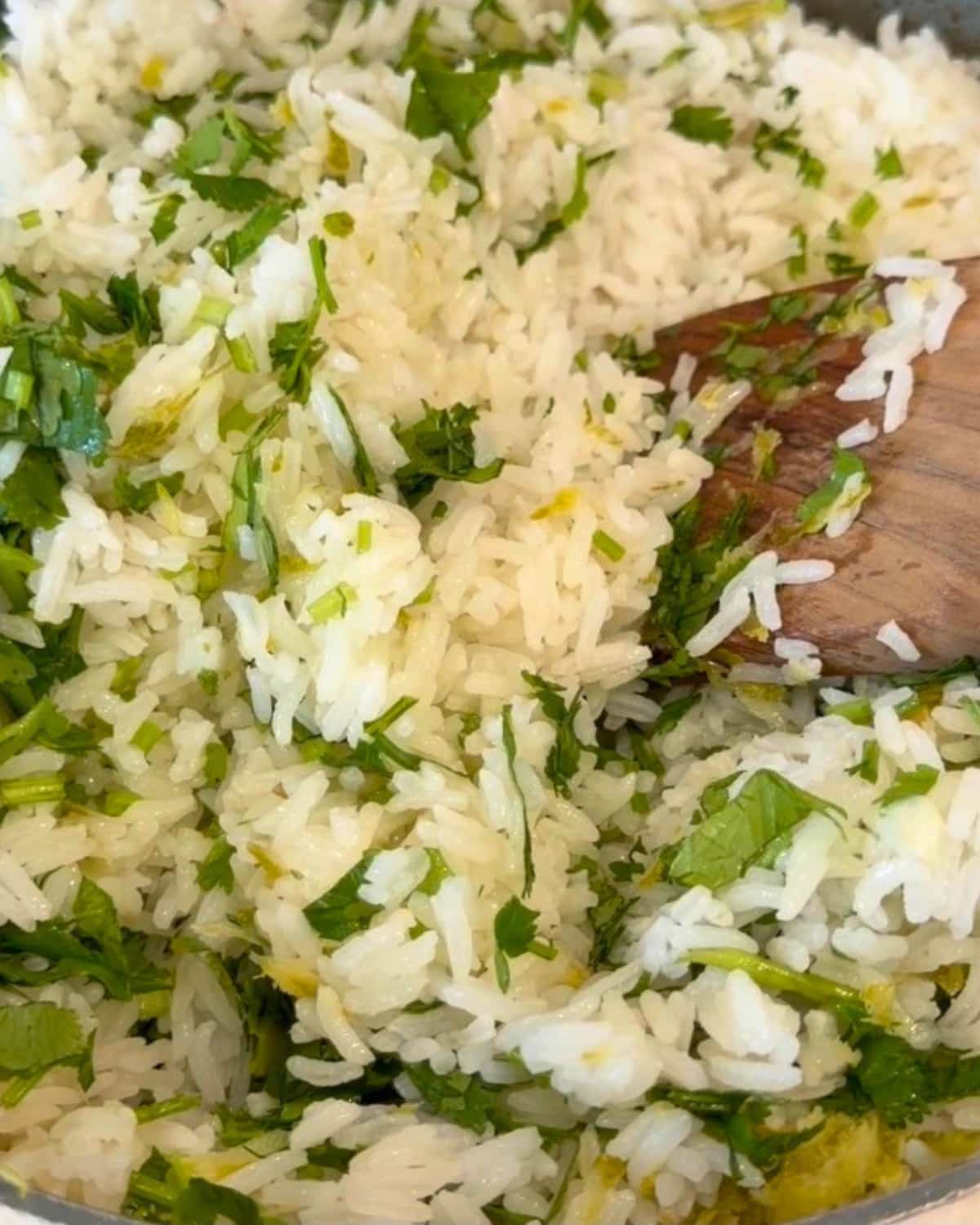 cilantro lime rice in skillet with a wodden spatula