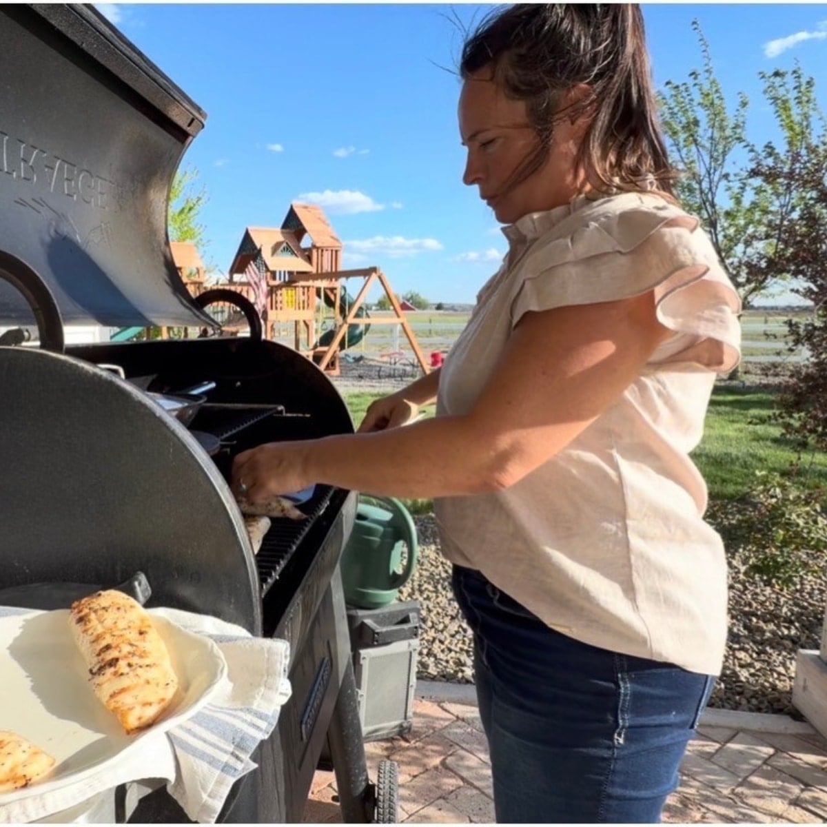 juliea grilling fish on the traeger