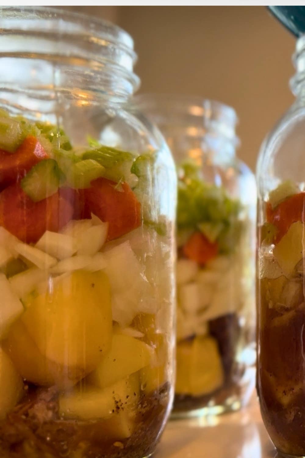 raw beef stew ingreidnets packed in layers in the jars