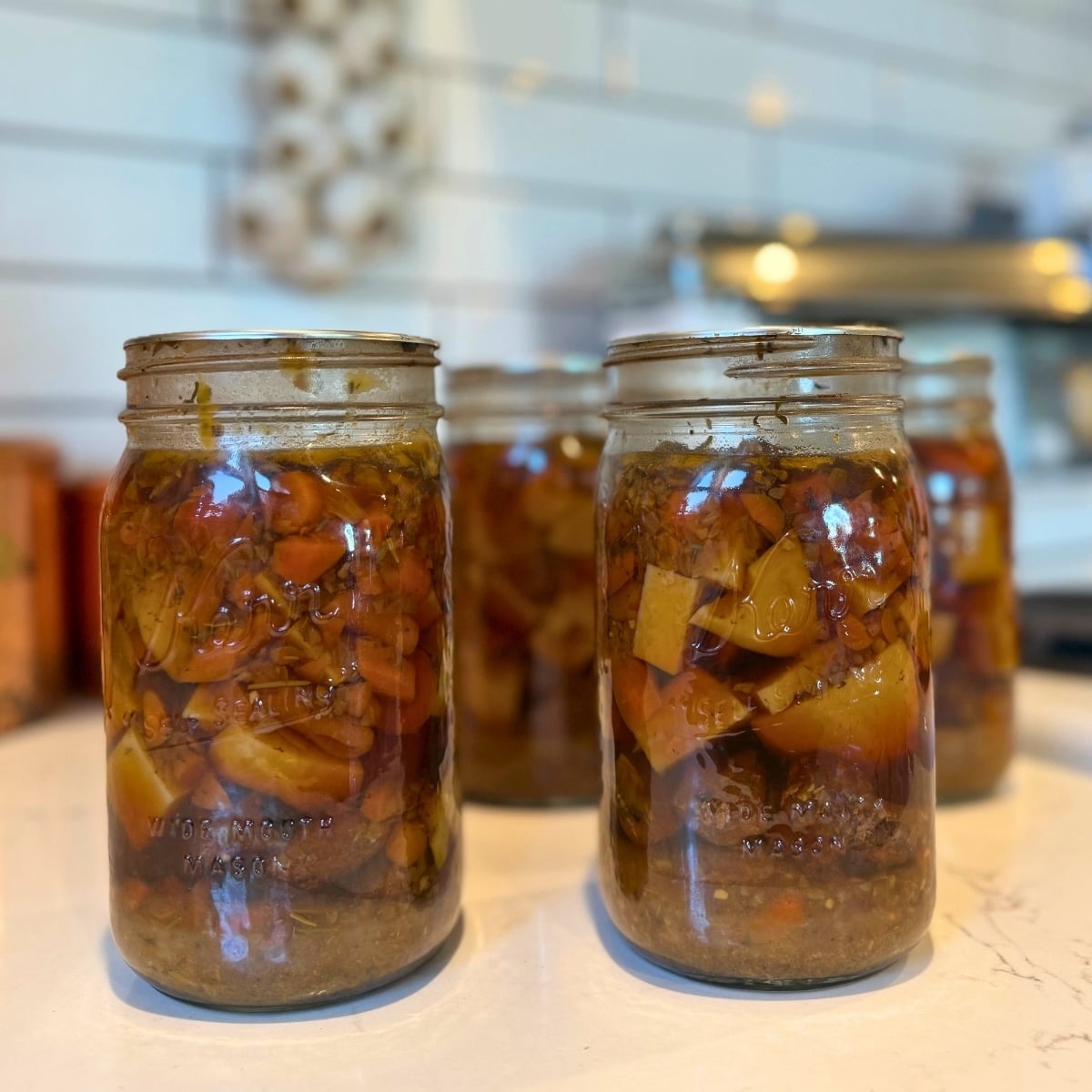jars of homemade canned beef stew on counter