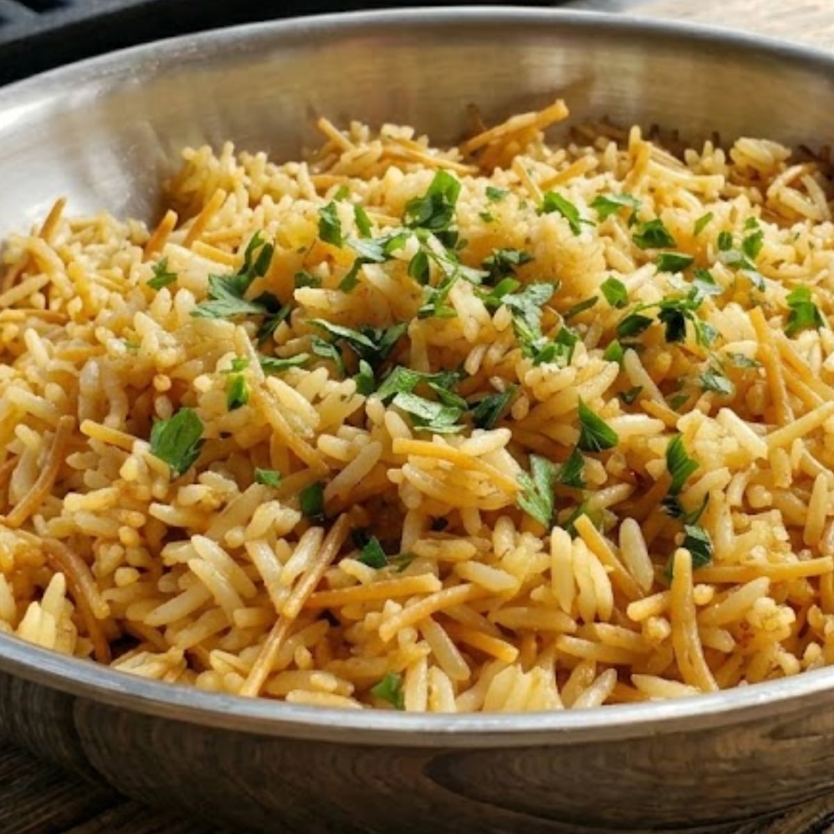 rice a roni in stainless steel skillet topped with fresh parsely