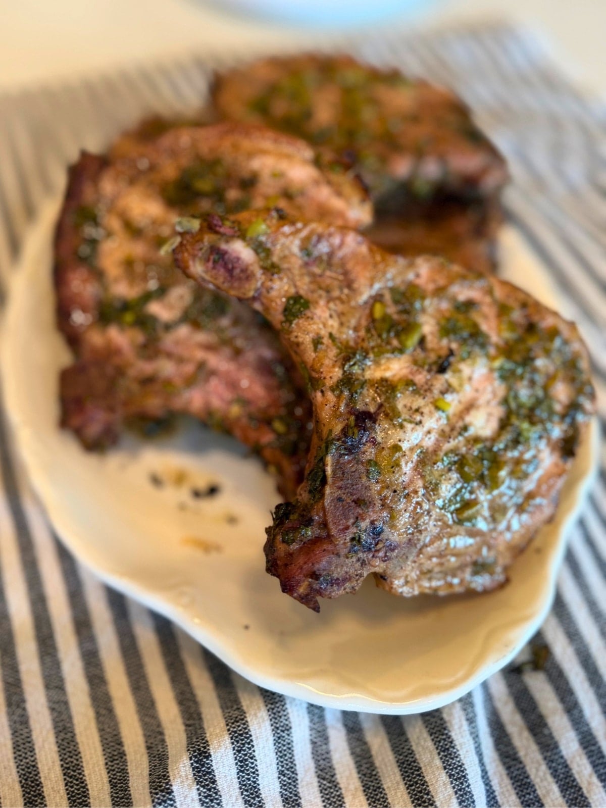 cilantro lime marinated and grilled bone in pork chops on platter