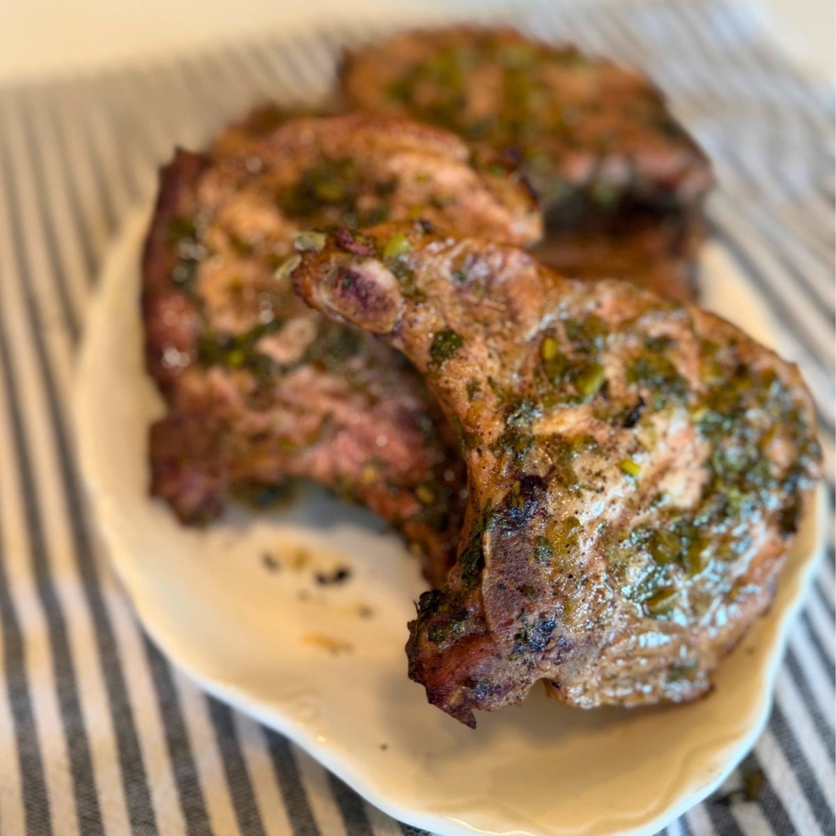 cilantro lime marinated and grilled bone in pork chops on platter (1200 x 1200 px)