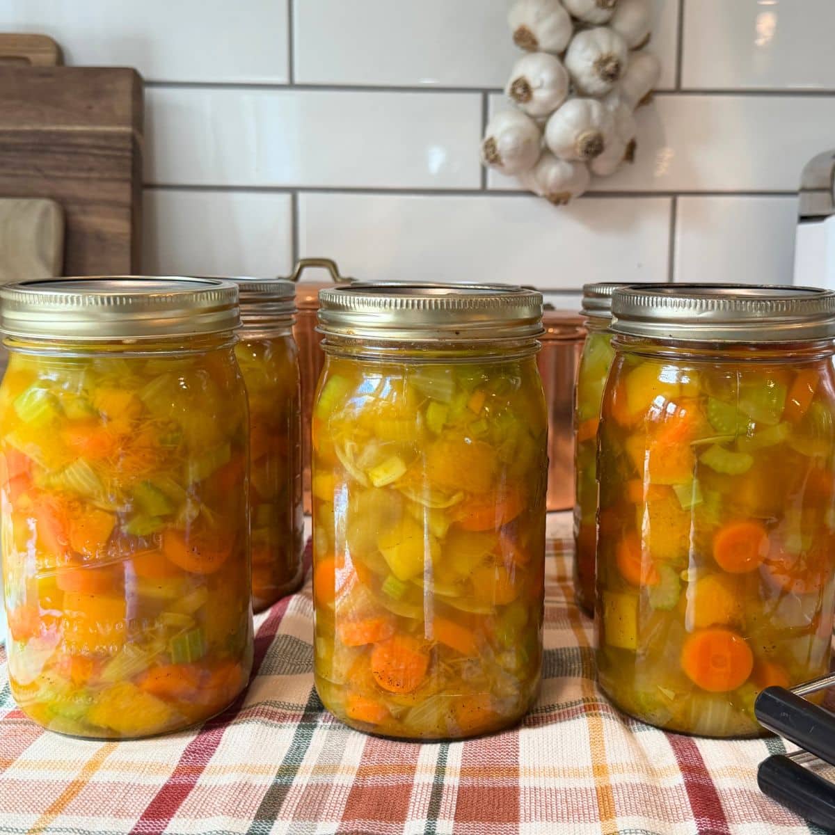 quart jars of butternut squash soup canning recipe on counter cooling