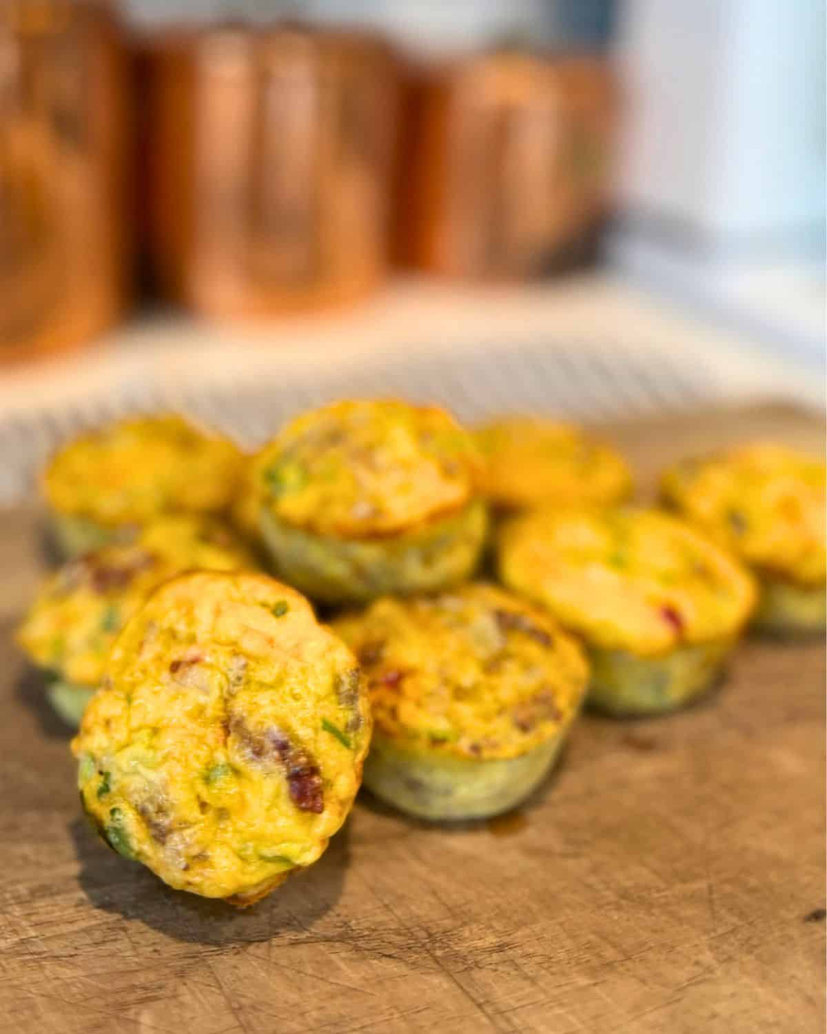 breakfast egg muffins cooling on wood cutting baord