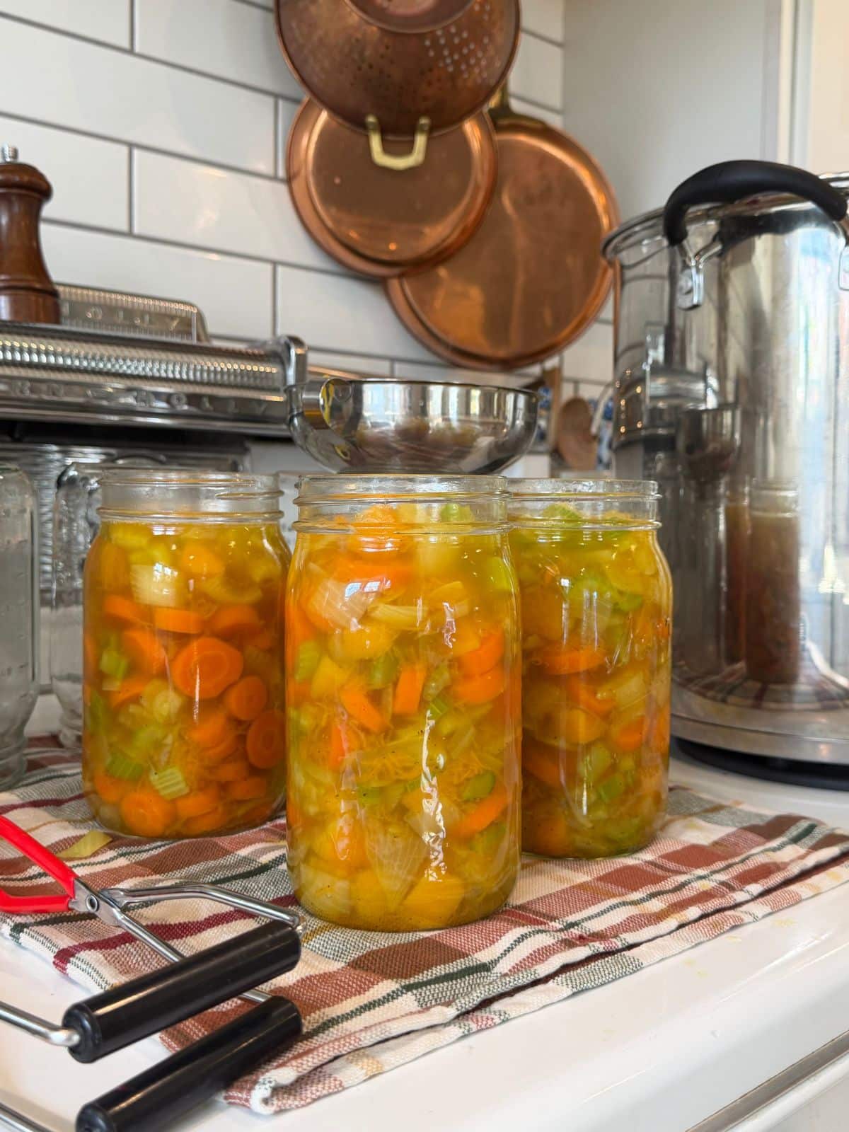 hot packing butternut squash soup canning recipe into quart jars usinga metal funnel