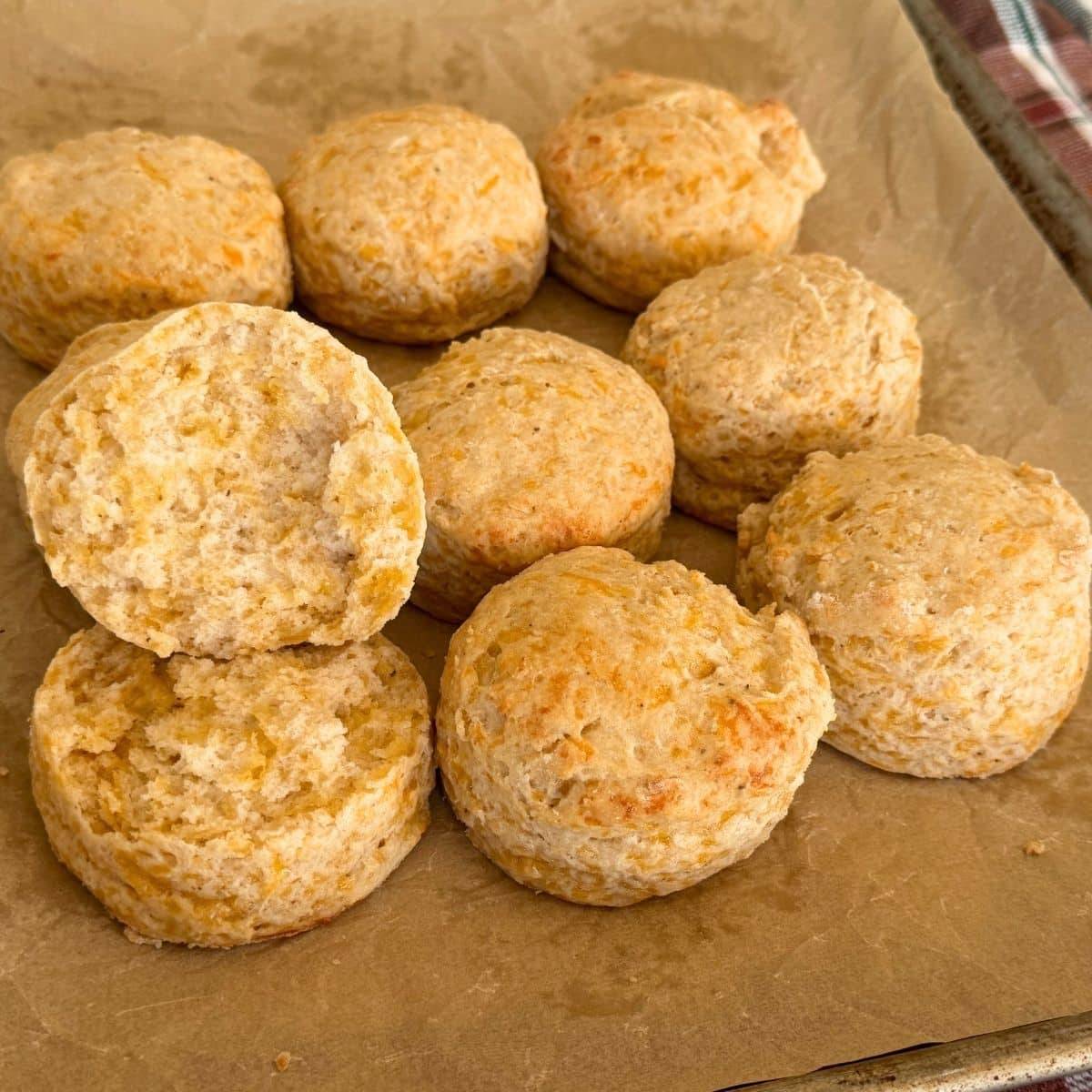 5 ingredient cheddar bay biscuits cooling on parchment lined baking tray