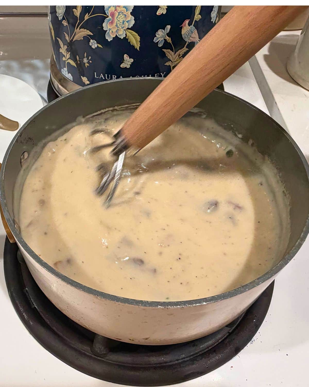 stirring cream of mushroom soup in saucepan on stove top