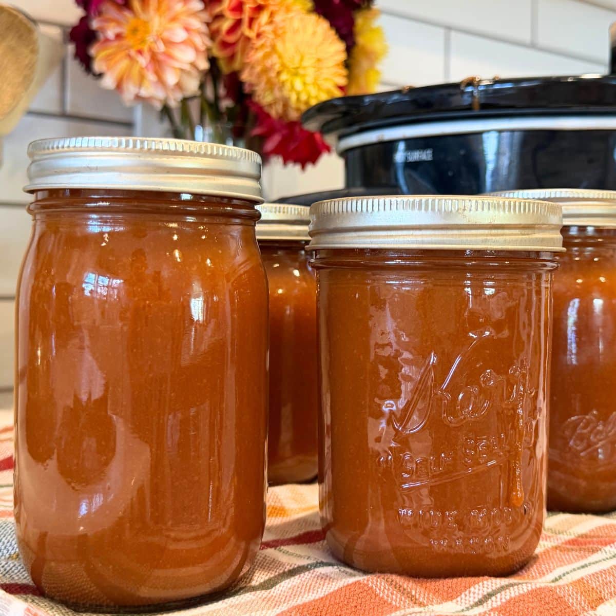 peach butter canning recipe in jars cooling on counter