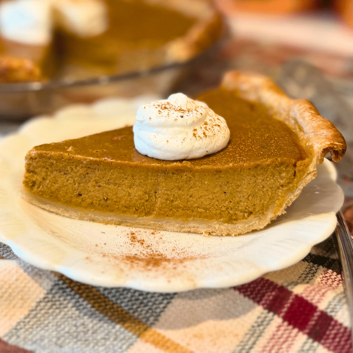 easy pumpkin pie recipe served on a plate with a dollop of whipped cream
