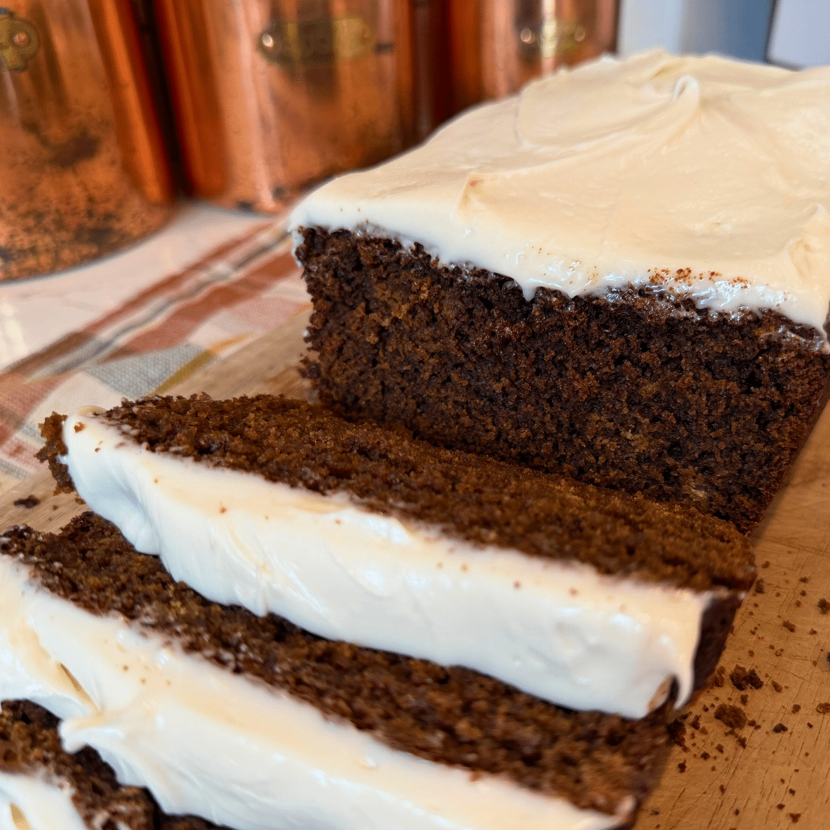 sourdough gingerbread sliced on a wood cutting baord